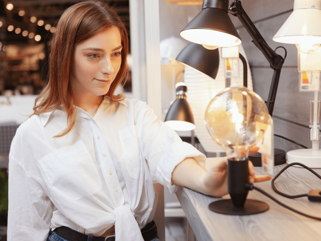 woman at store looking at small lamps